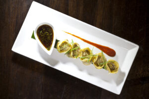 Duck Confit Pot Stickers with Oyster Sauce, Ginger & Scallions, Soy Dipping & Ripe Chili Sauce by Executive Chef Ashfer Biju