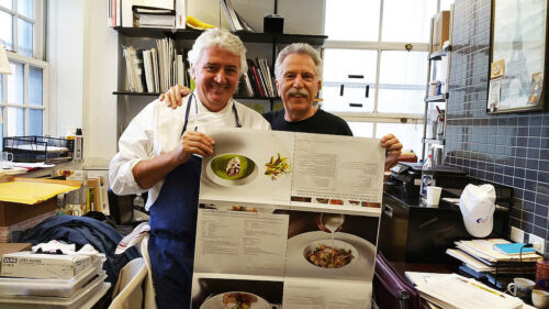 Battman and Chef Jean Louis Dumonet review the press sheets for Master Chefs of France cookbook.